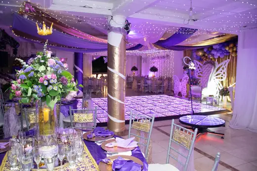 Salón montado con columnas envueltas y luz violeta